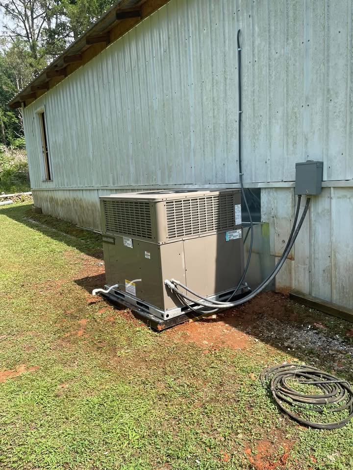 New package unit with clean electrical connections installed beside the mobile home